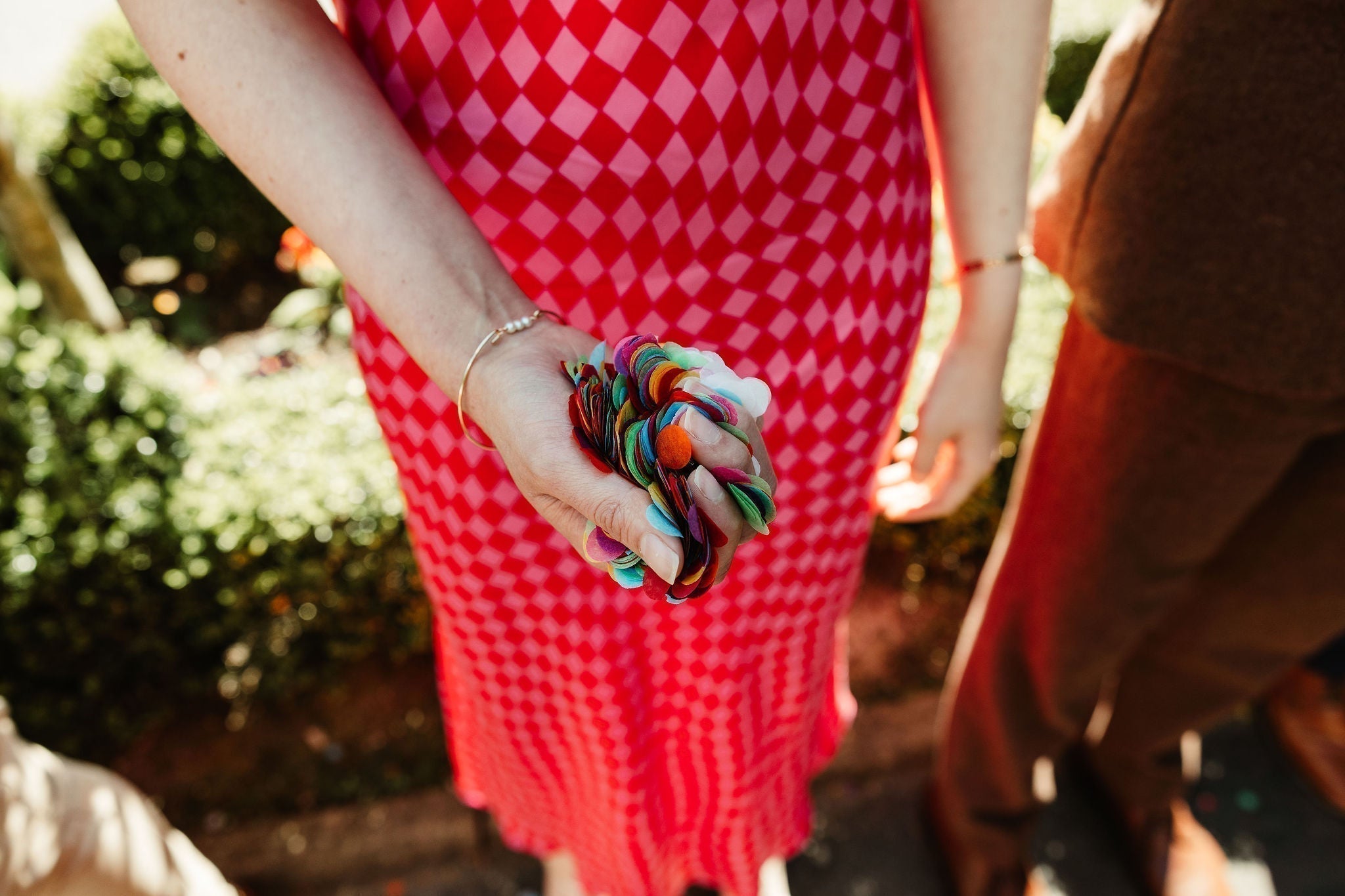 Wedding guest holding a handful of confet