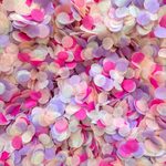 Flat lay of colourful circle confetti in a pastel mix of pink, purple, peach and ivory 