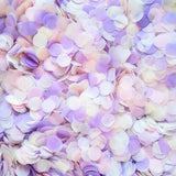 Blush pink, lilac purple and ivory confetti circles in a flat lay image. 